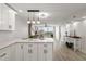 Modern kitchen with sleek white cabinetry, quartz countertops and stainless steel appliances at 700 Beach Ne Dr # 705, St Petersburg, FL 33701
