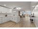A modern kitchen and open living area with luxury vinyl plank flooring and views of the outside at 700 Beach Ne Dr # 705, St Petersburg, FL 33701
