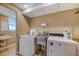 On-site laundry room with stainless steel sink and a washer and dryer available for use at 700 Beach Ne Dr # 705, St Petersburg, FL 33701