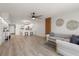 Open concept living room featuring luxury vinyl plank flooring and stylish decor at 700 Beach Ne Dr # 705, St Petersburg, FL 33701