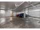 Parking garage featuring two cars, overhead lighting and ventilation with a concrete floor at 700 Beach Ne Dr # 705, St Petersburg, FL 33701