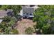Aerial shot of the home, showing the backyard, exterior decks, and the lush trees that frame the property at 705 Cypress St, Tarpon Springs, FL 34689