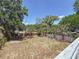 Shot of the wide open backyard and the surrounding trees from the home's back deck at 705 Cypress St, Tarpon Springs, FL 34689