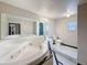 Bathroom featuring a sunken jetted tub, a toilet, and a large mirror at 705 Cypress St, Tarpon Springs, FL 34689