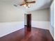 Bedroom features hardwood floors, updated ceiling fan, and a neutral color palette at 705 Cypress St, Tarpon Springs, FL 34689