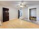 Bedroom with wood floors, ceiling fan, dark doors, closet, and doorway to other room at 705 Cypress St, Tarpon Springs, FL 34689