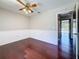 Bedroom with hardwood flooring, ceiling fan, and white wainscoting accents on the walls at 705 Cypress St, Tarpon Springs, FL 34689