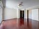 Large bedroom with a ceiling fan, hardwood floors, sliding glass doors, and a convenient closet at 705 Cypress St, Tarpon Springs, FL 34689