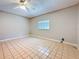 Spacious bedroom with neutral walls, a window, and ceiling fan at 705 Cypress St, Tarpon Springs, FL 34689
