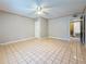 Spacious bedroom with neutral walls, a ceiling fan, and door at 705 Cypress St, Tarpon Springs, FL 34689
