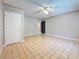 Spacious bedroom with neutral walls, a ceiling fan, and door at 705 Cypress St, Tarpon Springs, FL 34689