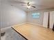Bedroom featuring light wood floors, a ceiling fan, and a window providing natural light at 705 Cypress St, Tarpon Springs, FL 34689