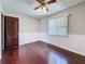 Empty bedroom featuring hardwood floors, ceiling fan, and natural light from the window at 705 Cypress St, Tarpon Springs, FL 34689