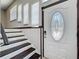 Elegant front door with decorative glass and a secure smart lock, leading to the staircase at 705 Cypress St, Tarpon Springs, FL 34689