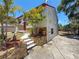 Close-up shot of the front exterior featuring stone facade, bright red door, and concrete steps at 705 Cypress St, Tarpon Springs, FL 34689