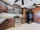 Kitchen featuring stainless steel appliances and plenty of dark wood cabinet storage at 705 Cypress St, Tarpon Springs, FL 34689