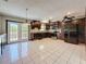 Spacious kitchen featuring dark wood cabinetry, stainless steel appliances, and ample countertop space at 705 Cypress St, Tarpon Springs, FL 34689