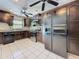 Updated kitchen with dark cabinets, stainless steel appliances, and ample storage space at 705 Cypress St, Tarpon Springs, FL 34689