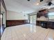 Spacious kitchen with dark cabinets, white tile floors, and natural light from the french doors at 705 Cypress St, Tarpon Springs, FL 34689