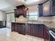 Kitchen boasts granite countertops, stainless steel sink, and sleek dark wood cabinetry at 705 Cypress St, Tarpon Springs, FL 34689