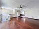 Open-concept living room boasting hardwood floors, ceiling fan, and access to the dining area at 705 Cypress St, Tarpon Springs, FL 34689