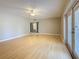 Bright living room featuring wood floors, ceiling fan, neutral paint and sliding doors at 705 Cypress St, Tarpon Springs, FL 34689
