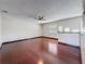 Bright living room showcasing hardwood floors, ceiling fan, and natural light from windows at 705 Cypress St, Tarpon Springs, FL 34689