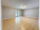 Spacious living room with wood floors, ceiling fan, and sliding glass doors to the exterior at 705 Cypress St, Tarpon Springs, FL 34689