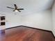 Spacious living room with dark hardwood floors, ceiling fan, and neutral wall color at 705 Cypress St, Tarpon Springs, FL 34689