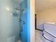 Blue tiled shower with a large shower head in a bathroom with a jetted tub at 705 Cypress St, Tarpon Springs, FL 34689