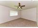 Neutral bedroom featuring carpeted floors and a ceiling fan at 7517 Oxwood St, North Port, FL 34287
