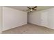 Spacious bedroom with neutral carpet, white walls, and a ceiling fan at 7517 Oxwood St, North Port, FL 34287