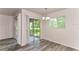 Bright dining area features modern flooring and sliding glass doors to the screened patio at 7517 Oxwood St, North Port, FL 34287