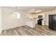 Updated kitchen features white cabinets, black appliances, and modern flooring at 7517 Oxwood St, North Port, FL 34287