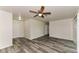 Bright living room featuring modern flooring, neutral walls, and a ceiling fan at 7517 Oxwood St, North Port, FL 34287
