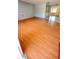 Spacious living room with bright laminate flooring, connecting to the kitchen for a convenient living space at 7734 Judith Cres, Port Richey, FL 34668