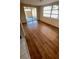 Open living room with wood-look flooring and lots of natural light, creating a warm and inviting space at 7734 Judith Cres, Port Richey, FL 34668