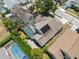 Aerial view of a home with a screened-in pool and solar panels on the roof at 7903 Lake Placid Ln, Trinity, FL 34655