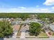 Suburban aerial of a home with a large tree in the front yard in a leafy neighborhood at 7903 Lake Placid Ln, Trinity, FL 34655