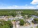 Beautiful aerial view of a residential area with mature trees and a tranquil lake nearby at 7903 Lake Placid Ln, Trinity, FL 34655