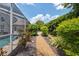Landscaped backyard featuring a gravel path leading to an outdoor seating area at 7903 Lake Placid Ln, Trinity, FL 34655