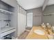 Bathroom features a desk/vanity area with a granite sink, and white shower curtain covering the tub at 7903 Lake Placid Ln, Trinity, FL 34655