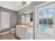 Bathroom featuring a granite vanity with an exterior door leading to a private pool area at 7903 Lake Placid Ln, Trinity, FL 34655