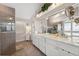 Updated bathroom boasts dual sinks, white cabinets, tile floor and a walk-in shower at 7903 Lake Placid Ln, Trinity, FL 34655
