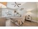 Cozy bedroom with natural light featuring a queen-size bed and decorative bedside tables at 7903 Lake Placid Ln, Trinity, FL 34655