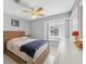 Bedroom features neutral walls with a woven queen bed and bright natural lighting at 7903 Lake Placid Ln, Trinity, FL 34655