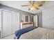 Bedroom features grey walls, white closet doors, a dresser, and a bed at 7903 Lake Placid Ln, Trinity, FL 34655