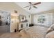 Inviting bedroom features neutral walls, ceiling fan, wood look flooring, and lots of natural light at 7903 Lake Placid Ln, Trinity, FL 34655