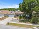 Charming home featuring well-maintained landscaping, a two-car garage, and lovely curb appeal at 7903 Lake Placid Ln, Trinity, FL 34655