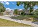 Inviting front yard showcasing lush landscaping and a well-maintained home exterior at 7903 Lake Placid Ln, Trinity, FL 34655